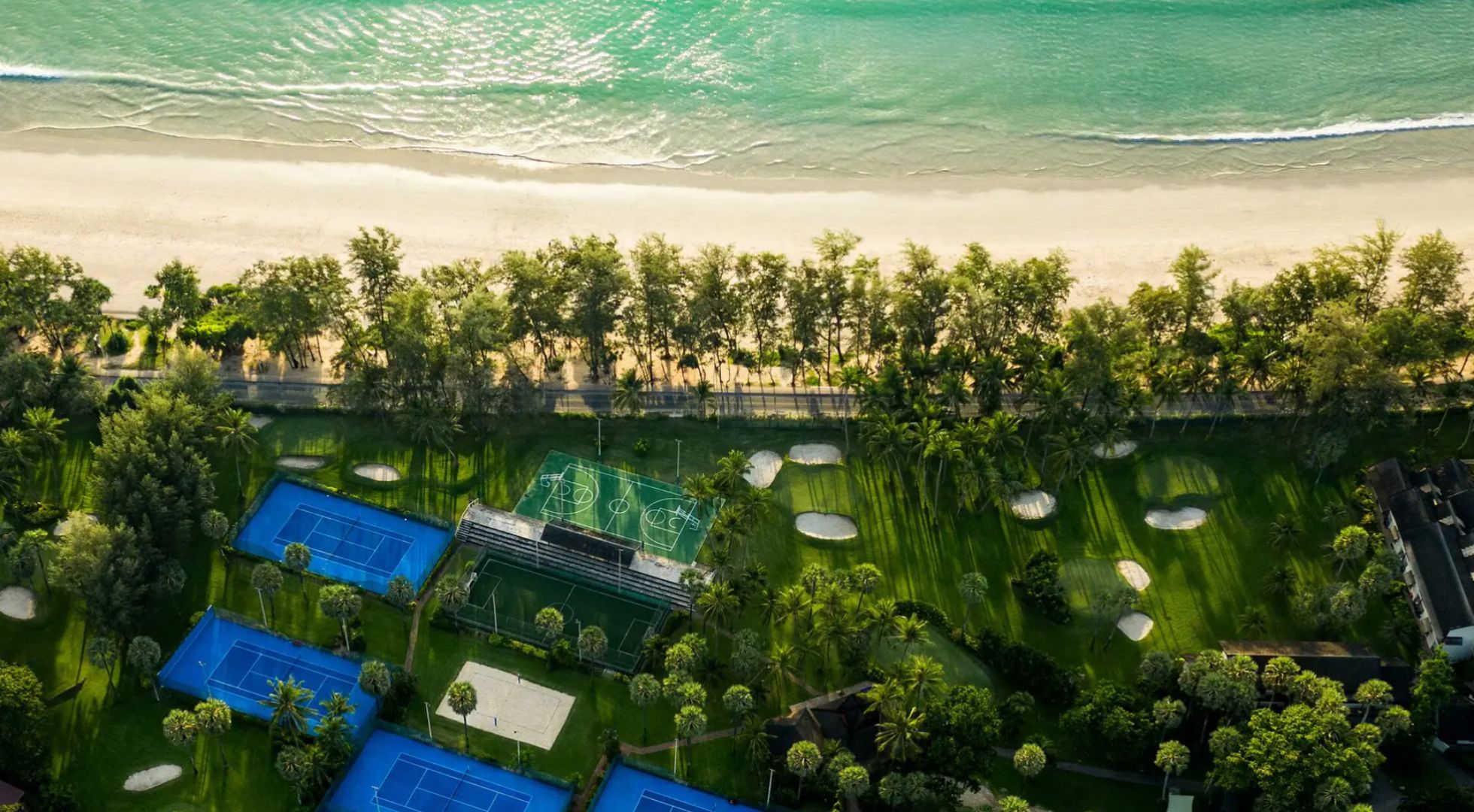 An aerial view of the Club Med Phuket compound featuring tennis courts and a basketball court.